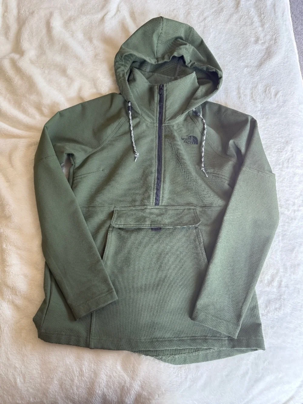 olive green The North Face Tekno Ridge Hoodie features a kangaroo pocket